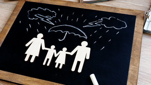 Health and life insurance. Blackboard with family figures in the agency.
