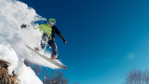 snowboarder is jumping with snowboard from snowhill